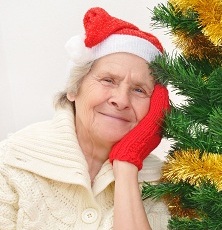 Elderly lady in Santa hat and mitt